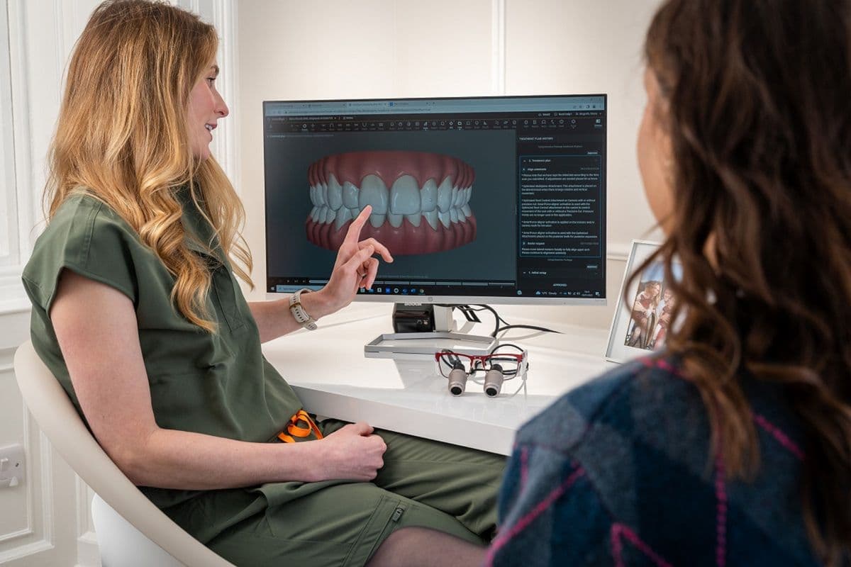 A clinician discussing a patient's digital dental scan on screen