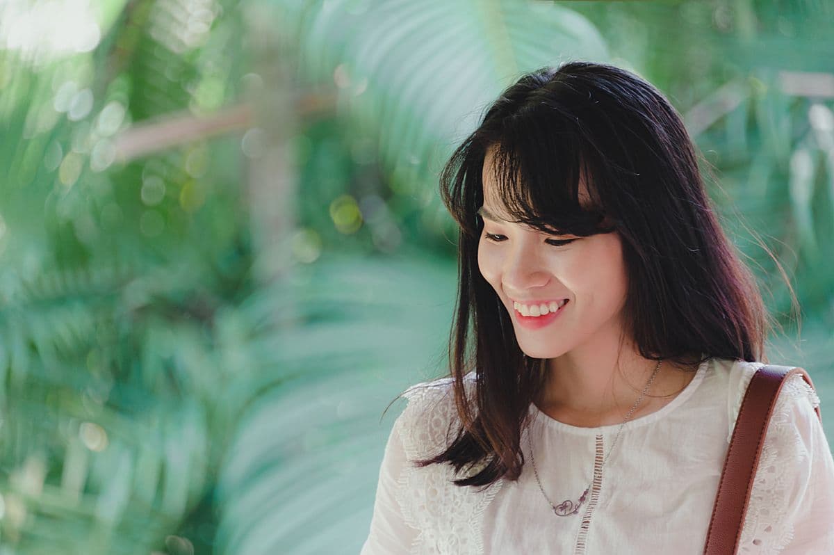 A woman with a bright, healthy smile in natural light