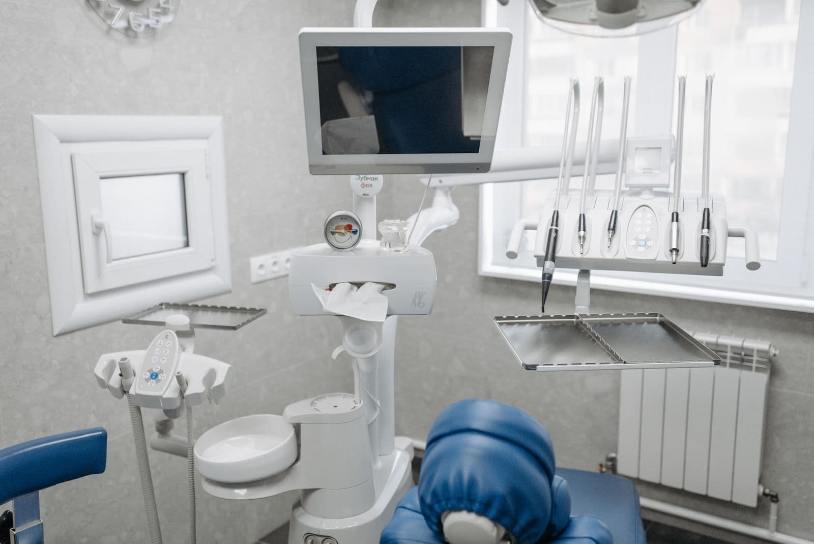 A high-tech dental treatment room with a chairside monitor and modern instruments