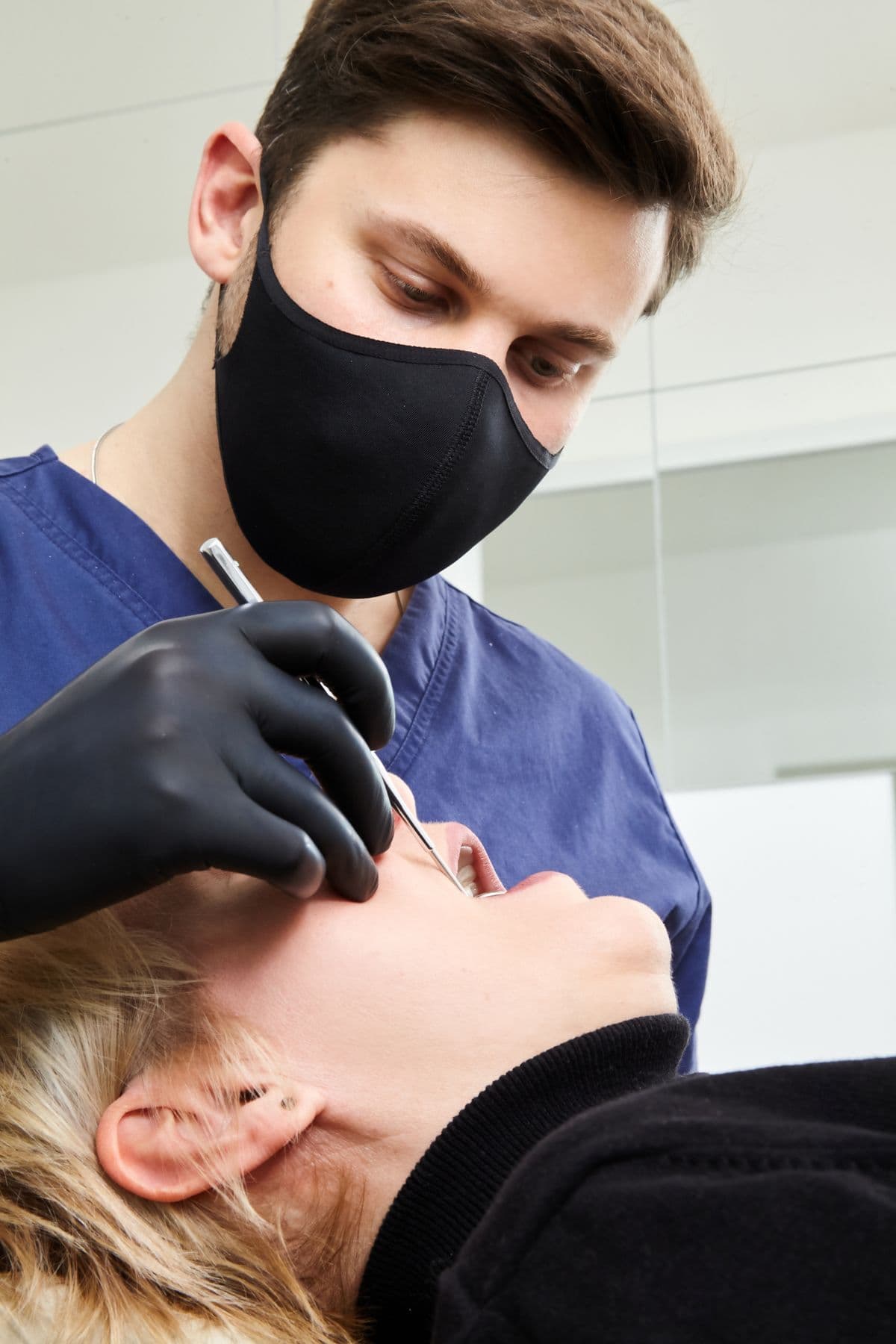 A dentist examining a patient's teeth during a modern dental exam